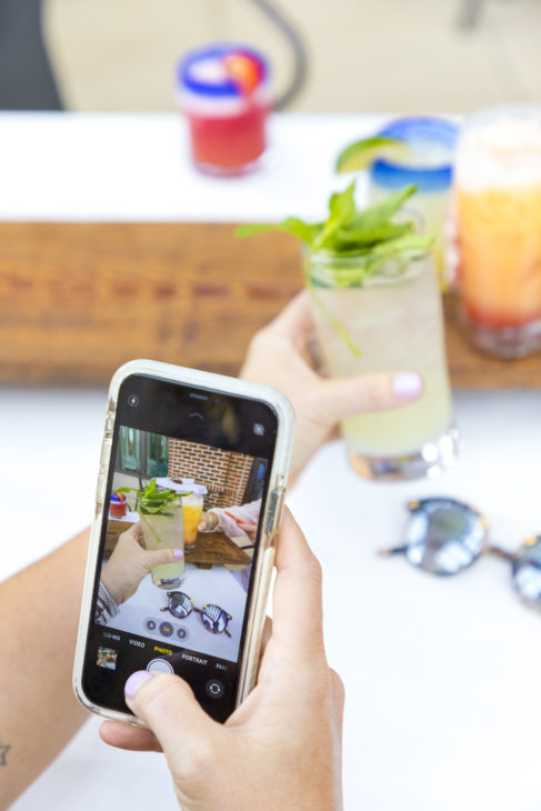 Taking a quick photo of a cucumber mojito from Sol Y Luna